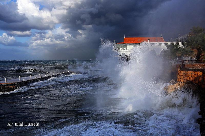 Huge waves crash on the sea defense wall of a restaurant, at the Beirut...