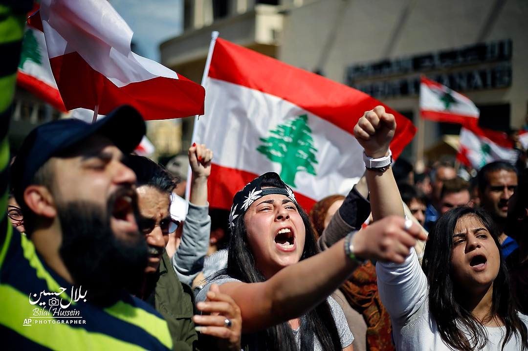 Lebanese anti-government protesters shout slogans during a protest against...