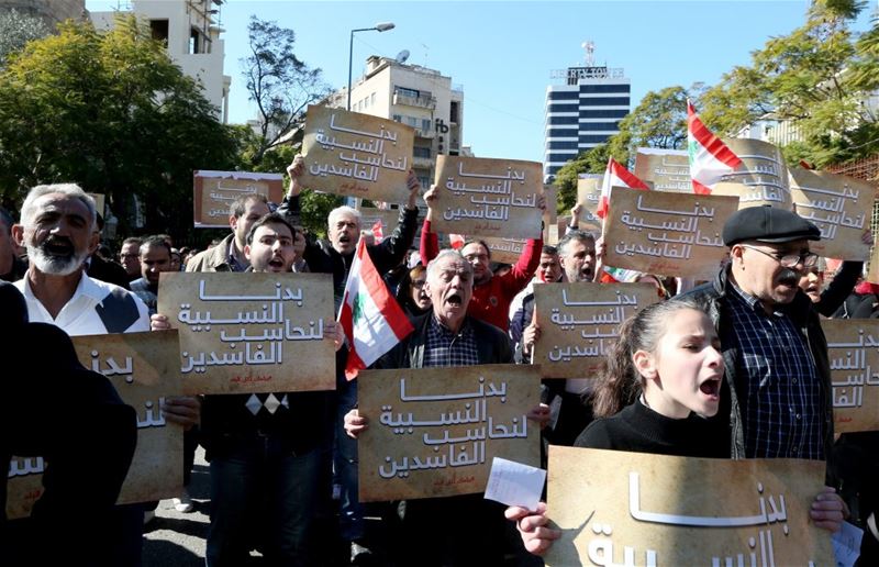 Lebanese demonstrators carry placards reading ‘We need an election at proportion law’, in Beirut. (NABIL MOUNZER / EPA)