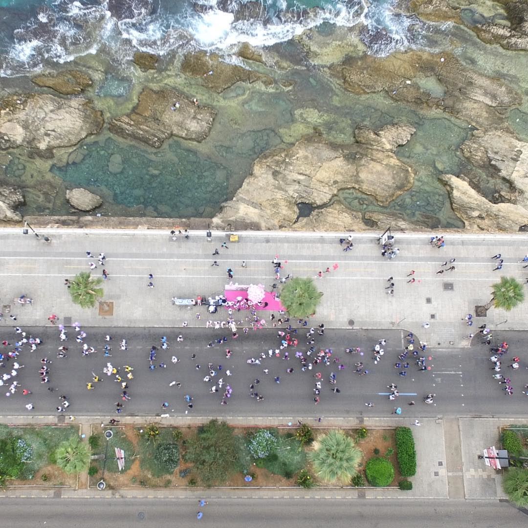 Live above the Lebanese Breast Cancer Foundation stand as the runners pass... (Beirut Marathon)