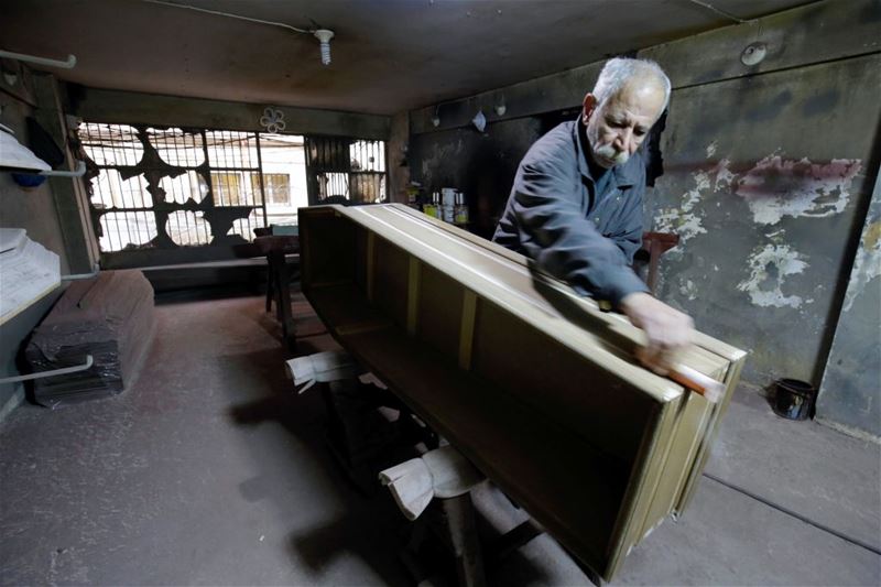 Michel Homsi, the last craftsman building handmade coffins in Tripoli. (IBRAHIM CHALHOUB / AFP)