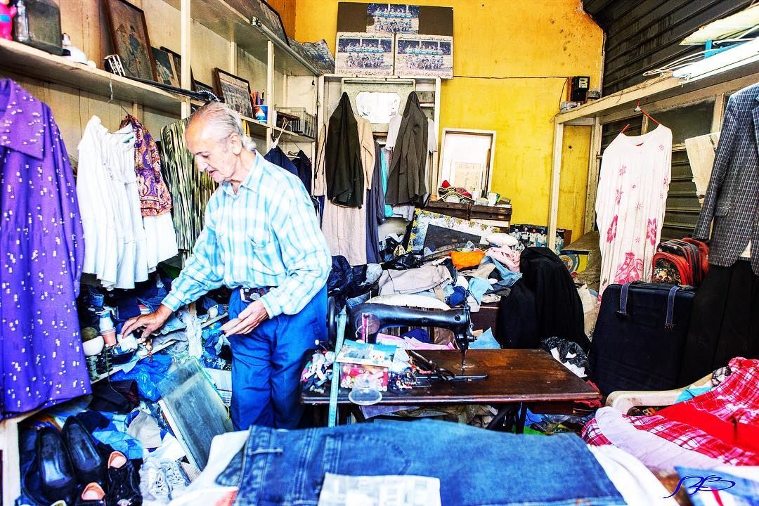 Old tailor at his shop