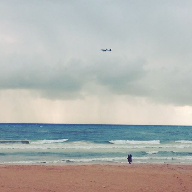 People playing on the beach and a plane passing by scene  love  storm ...