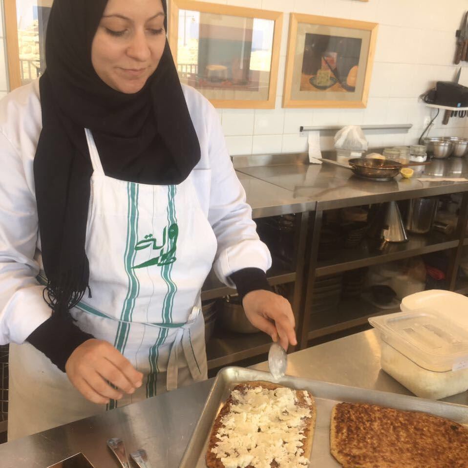 Racha preparing Jrisheh bel Jebneh at Tawlet Saida. Jrisheh is a flatbread...