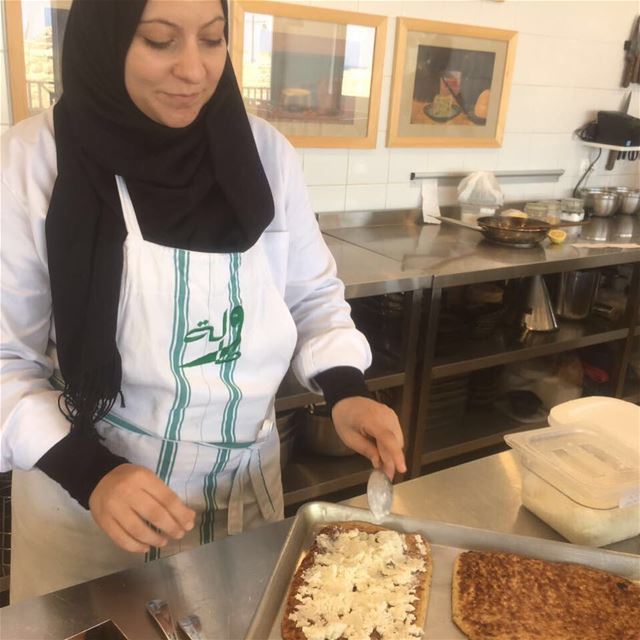 Racha preparing Jrisheh bel Jebneh at Tawlet Saida. Jrisheh is a flatbread...