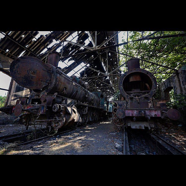 Rusted locomotives are seen at the defunct train station, in the northern...
