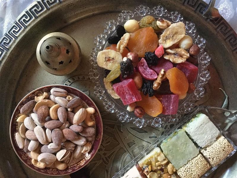 Sharing plates of dried fruit  زبيب , nuts  بزورات  and cups of tea  شاي ... (Guildford West)