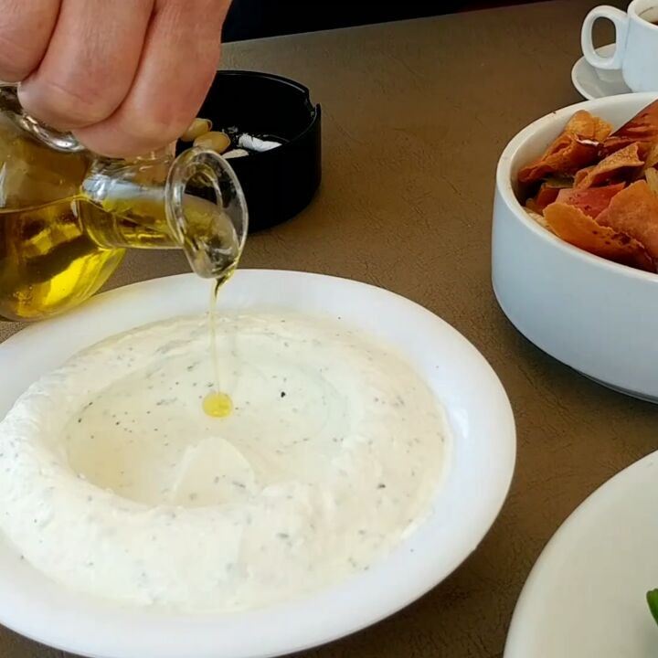 Simple circling motion with the best olive oil, best labneh, best olives,... (Al Rawda Cafe' & Restaurant)