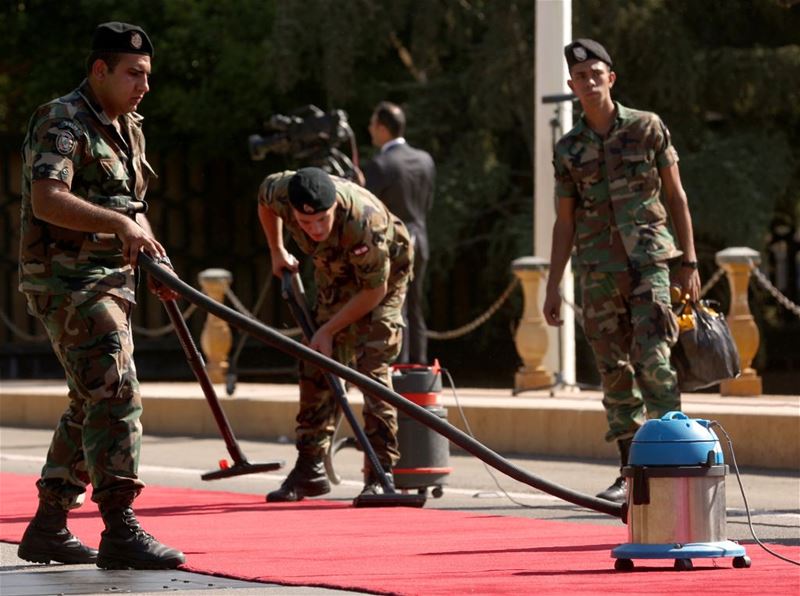 Soldiers Grooming the Red Carpet Prior to the President Arrival