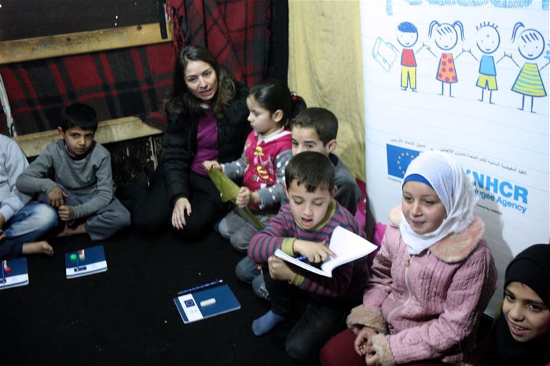 Syrian refugee children sit outside their makeshift home in a slum in Dbayeh. 