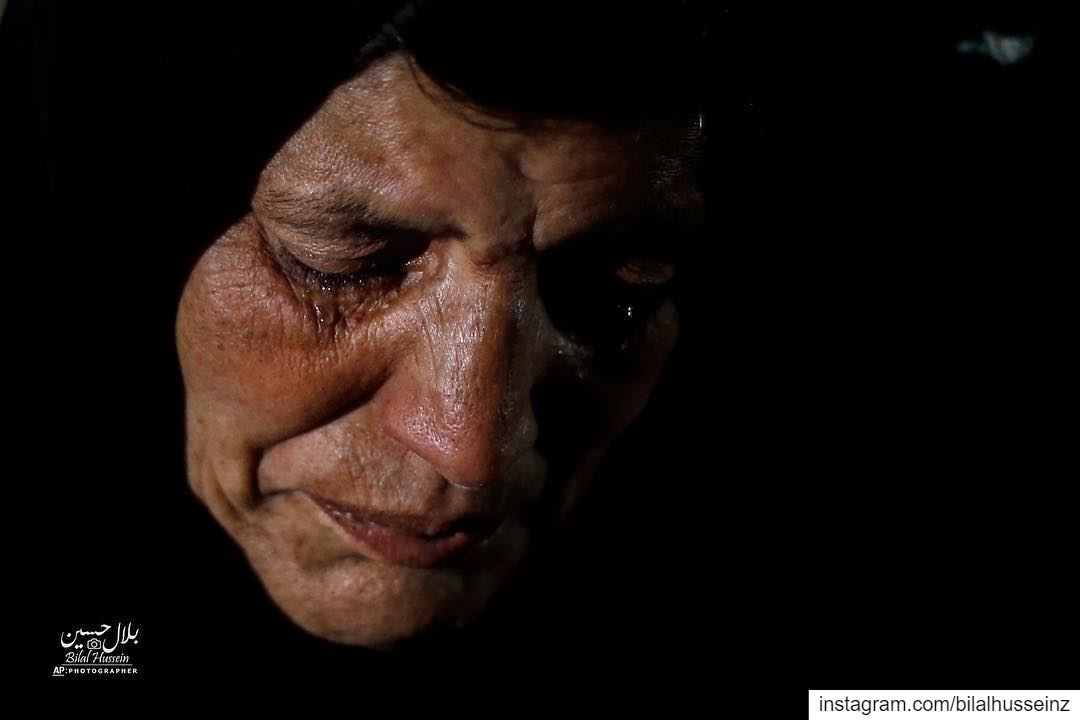 Syrian refugee Itihad Sayed weeps, in Ouzai refugee compound, in the...