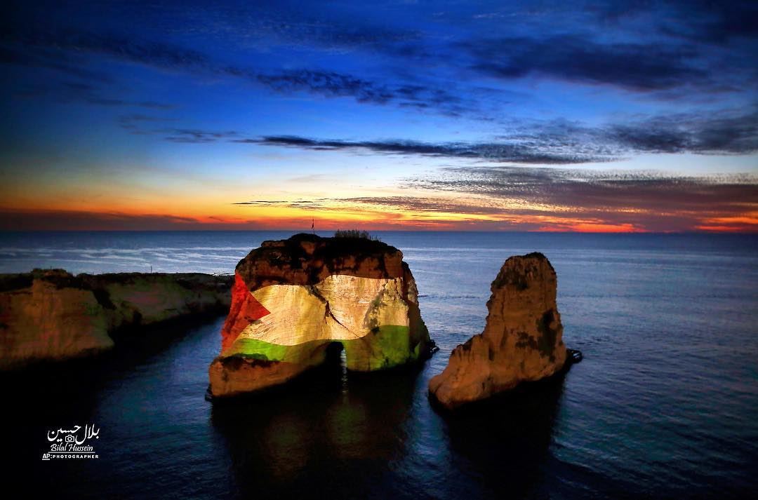 The landmark Raouche sea rock is illuminated by a giant Palestinian flag...