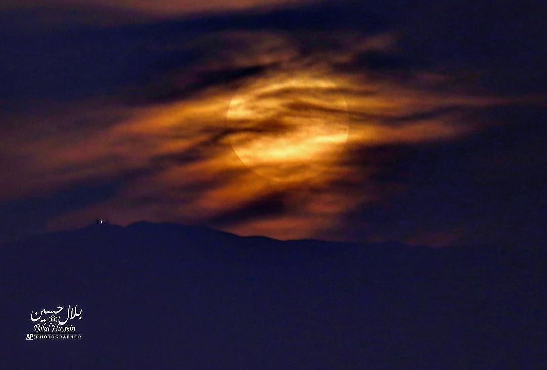 The moon rises over the Mount Lebanon mountain range, Monday, Nov. 14,...