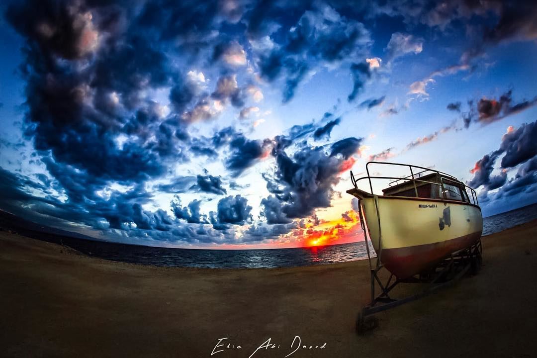 The scene speaks for itself 🌅  sunset  clouds  beach  boat  coast  sea ... (Boulevard Amshit)