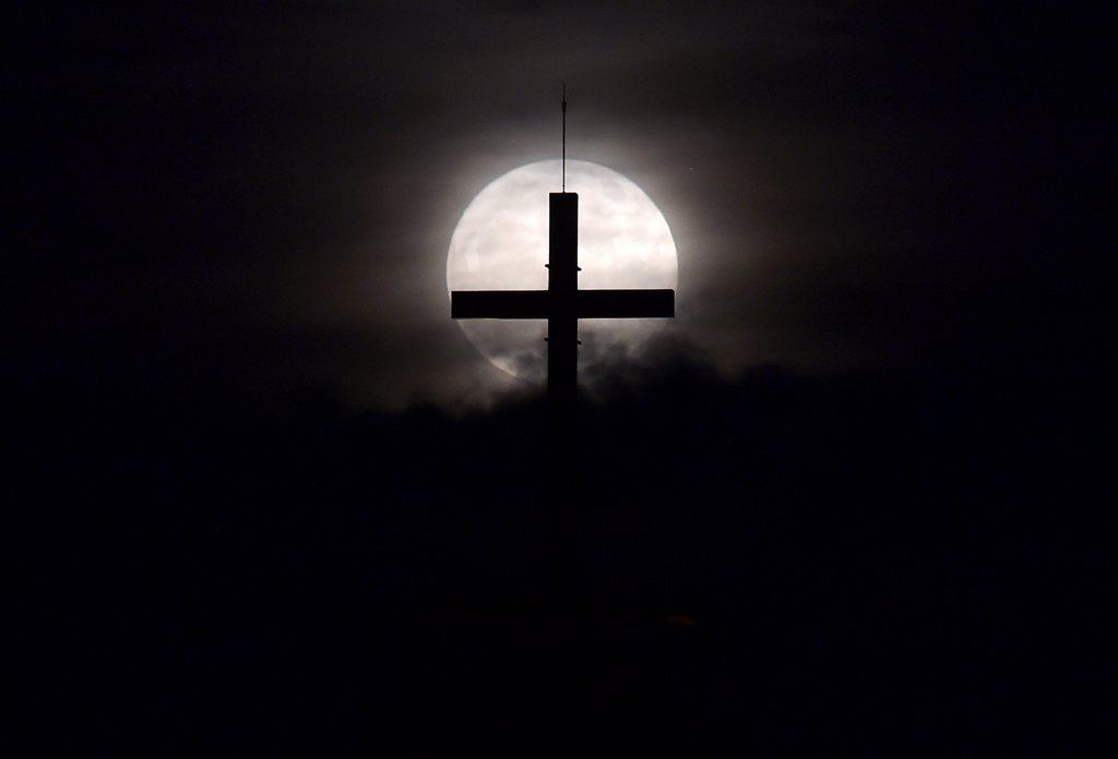 The supermoon rises behind a cross at downtown Beirut. 
