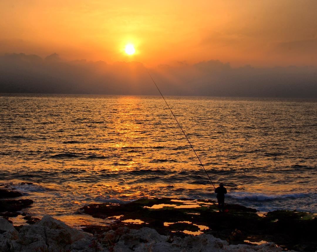 Trying to catch the sun or a fish fishermen  sunset  sky  clouds  sun ... (El Rmaileh, Mont-Liban, Lebanon)
