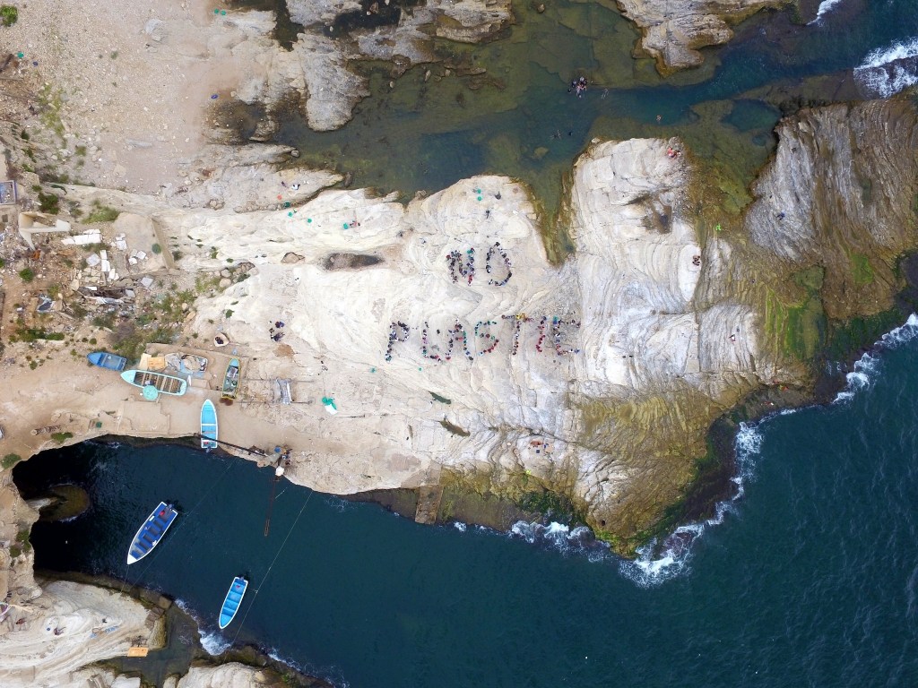 Volunteers forming by their bodies the word ‘No Plastic’ after cleaning the beach at al-Rawche area in Beirut, Lebanon. (GREENPEACE / EPA)